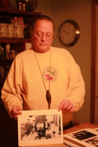 Saginaw Chippewa elder Terry Bonnau holds up a photo of his family. Proof of tribal lineage is necessary for membership.
