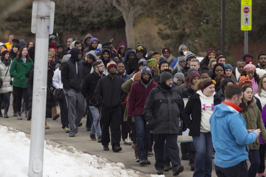Central Michigan University students and Mount Pleasant community members march at the Dr. Martin Luther King Jr. Peace March and Vigil on January 19, 2015. (Photo I Max Barth) 
