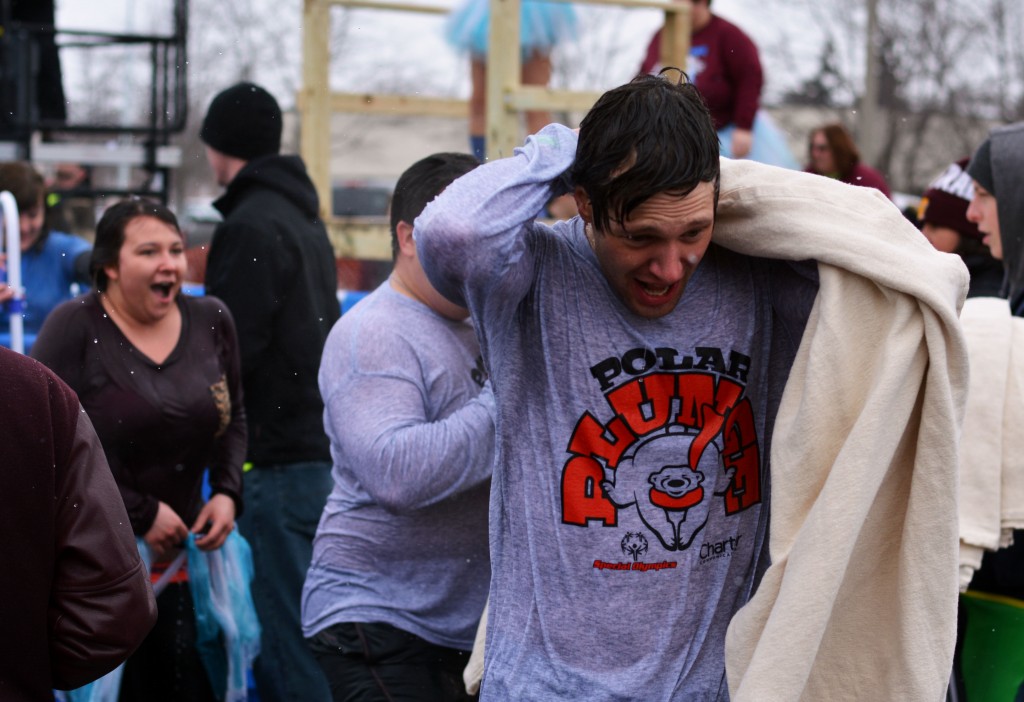 Participants run to get inside and out of the cold after jumping into the freezing water for the Mount Pleasant Polar Plunge. (Photo | Andrea Henk)