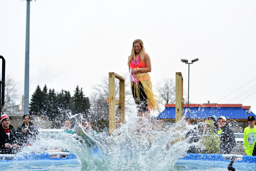 A woman dressed as a "Barbie" smiles as her teammate, who was dressed as "Ken," causes a great splash during the Mount Pleasant Polar Plunge. (Photo | Andrea Henk)