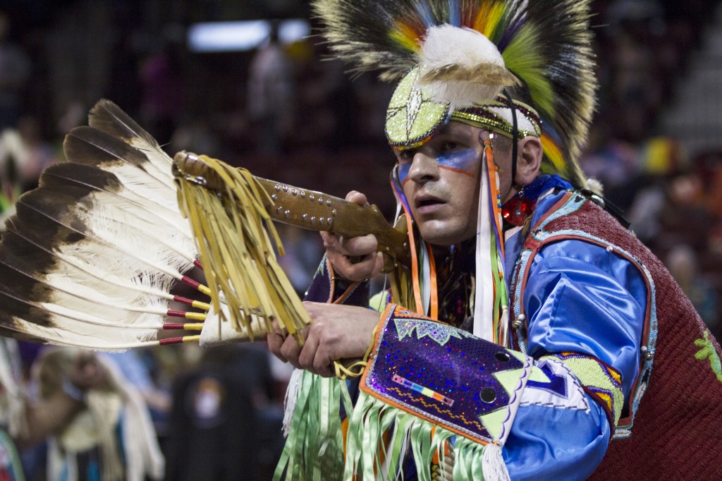Stewart Boyvin stares into the crowd while dancing during the Anishinaabe Pow wow in McGuirk Arena. (Photo I Rich Drummond) 