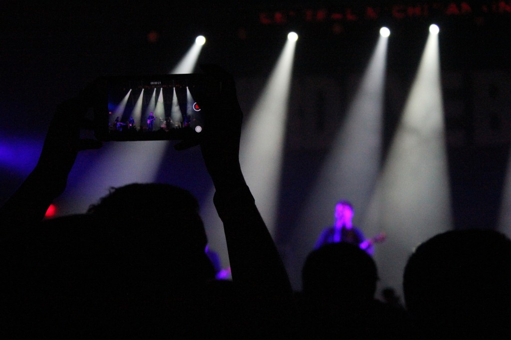 A fan takes a Snapchat video during a song played by Third Eye Blind in the McGuirk Arena on the campus of Central Michigan University, Friday, October 2, 2015.