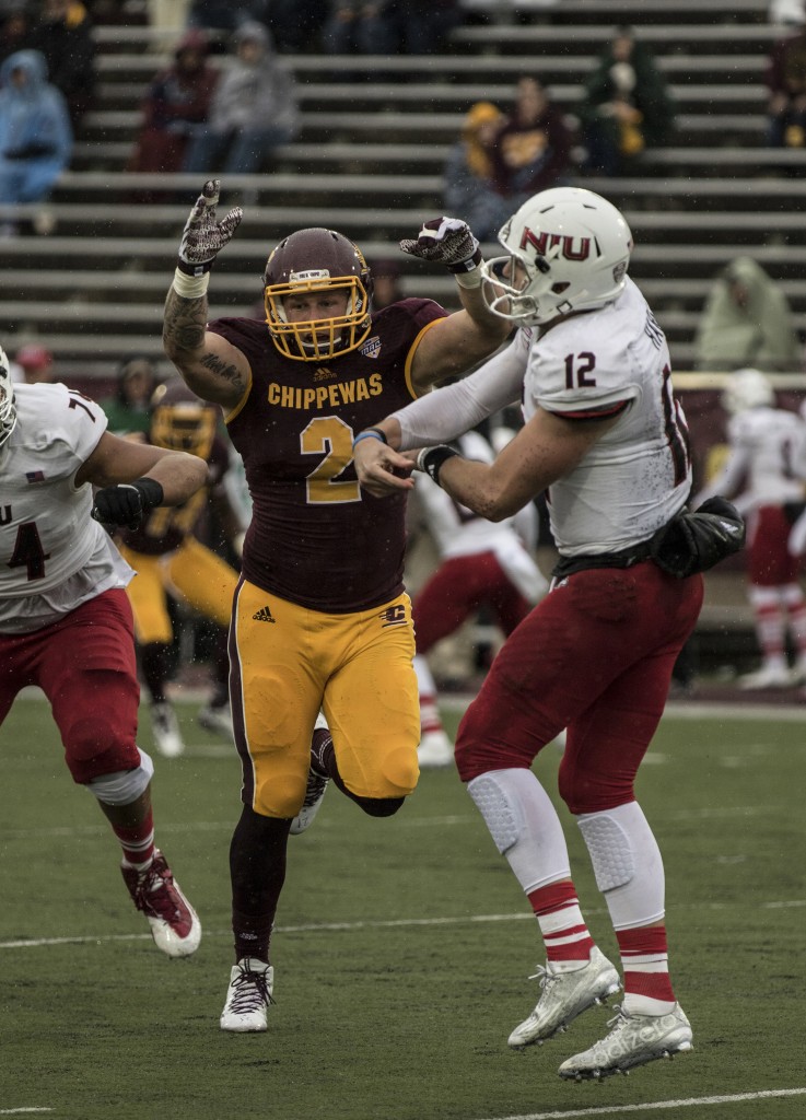 Blake Serpa, 2, rushes Drew Hare, 12, during the football game against Northern Illinois University on the campus of Central Michigan University, Mt. Pleasant, MI, Sunday, October 3, 2015.
