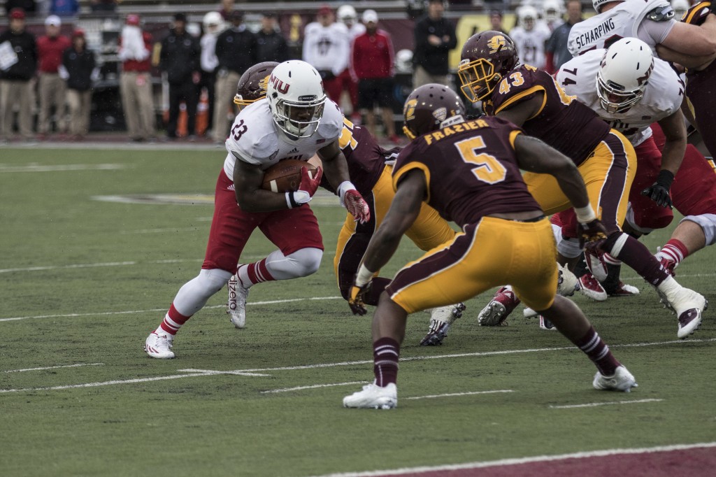 Jordan Huff, 23, looks for the endzone against Kavon Frazier, 5, and Tim Hamilton, 43, during the football game against Northern Illinois University on the campus of Central Michigan University, Mt. Pleasant, MI, Sunday, October 3, 2015.