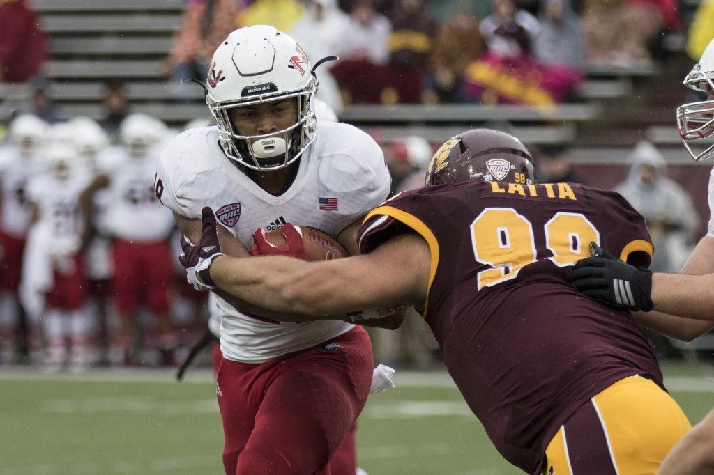 Jeffery Hill, 28, is wrapped up by Kelby Latta, 99, during the football game against Northern Illinois University on the campus of Central Michigan University, Mt. Pleasant, MI, Sunday, October 3, 2015.