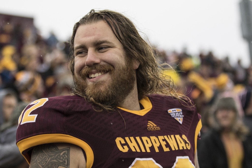 Mike Zenk, 92, smiles to a teammate during the football game against Northern Illinois University on the campus of Central Michigan University, Mt. Pleasant, MI, Sunday, October 3, 2015.