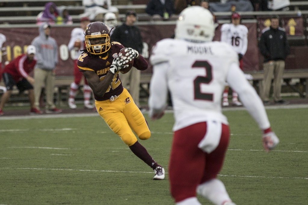 Corey Willis, 82, looks to evade Marlon Moore, 2, during the football game against Northern Illinois University on the campus of Central Michigan University, Mt. Pleasant, MI, Sunday, October 3, 2015.