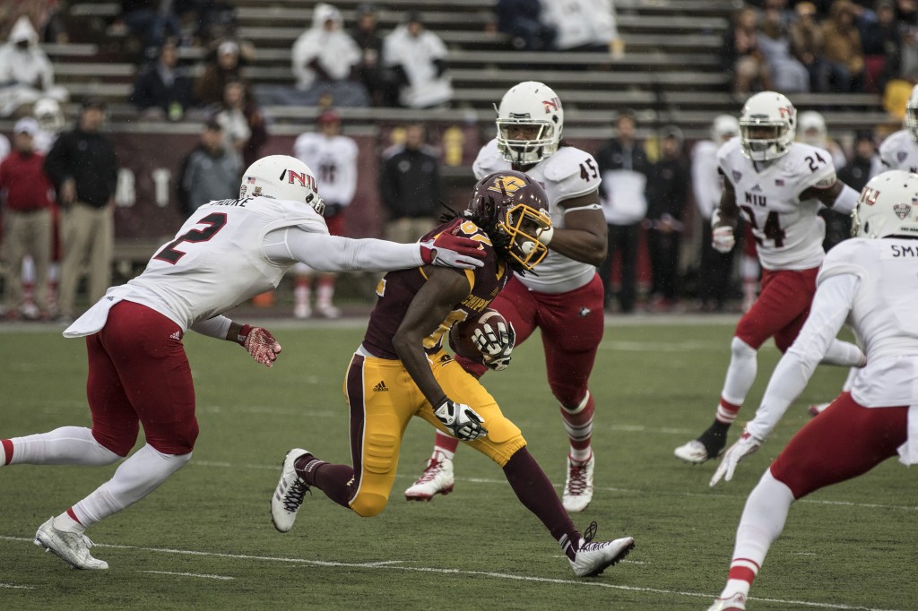Corey Willis, 82, tries to break free from Marlon Moore, 2, during the football game against Northern Illinois University on the campus of Central Michigan University, Mt. Pleasant, MI, Sunday, October 3, 2015.