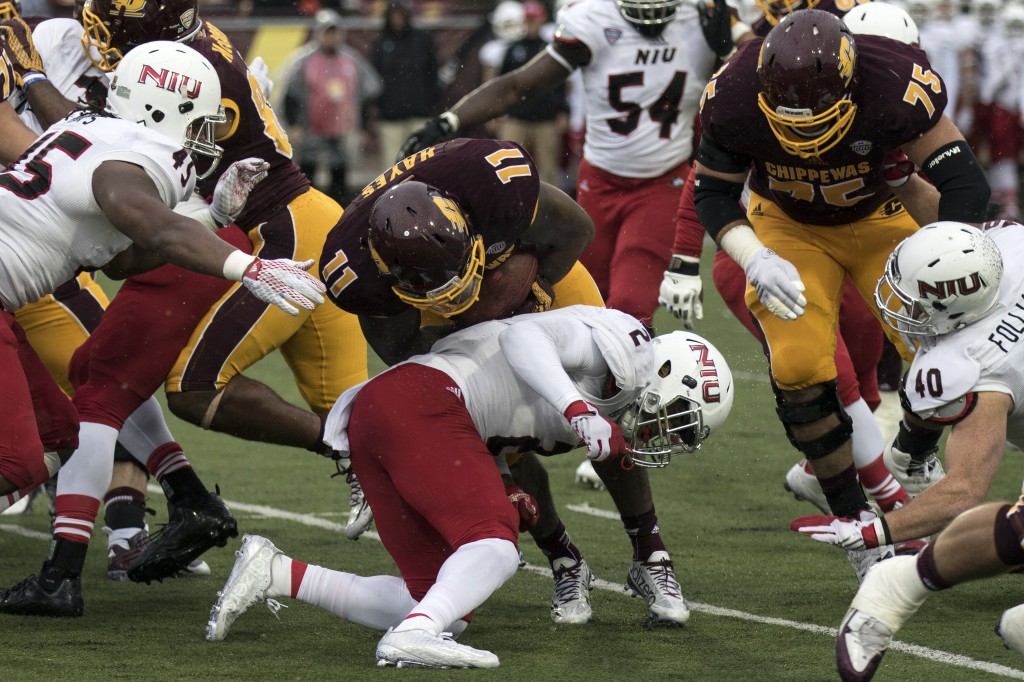 Jahray Hayes, 11, is tackled by Marlon Moore, 2, during the football game against Northern Illinois University on the campus of Central Michigan University, Mt. Pleasant, MI, Sunday, October 3, 2015.