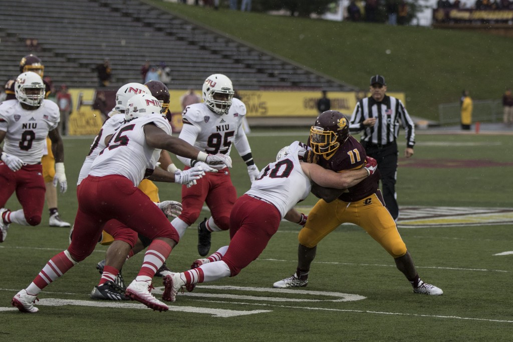 Jahray Hayes, 11, fights a tackle against Sean Folliard, 40, during the football game against Northern Illinois University on the campus of Central Michigan University, Mt. Pleasant, MI, Sunday, October 3, 2015.