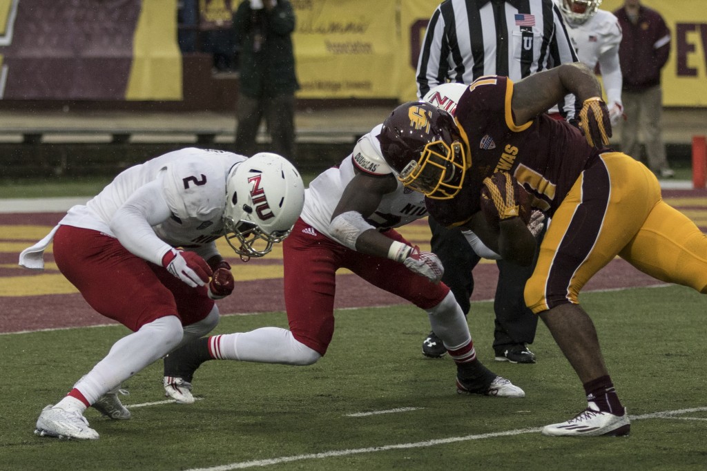 Jahray Hayes, 11, goes head to head against Marlon Moore, 2, during the football game against Northern Illinois University on the campus of Central Michigan University, Mt. Pleasant, MI, Sunday, October 3, 2015.