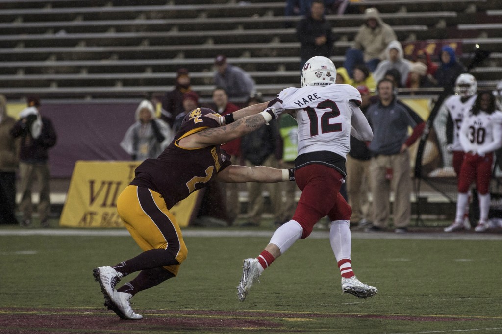 Blake Serpa, 2, clinches to Drew Hare, 12, during the football game against Northern Illinois University on the campus of Central Michigan University, Mt. Pleasant, MI, Sunday, October 3, 2015.