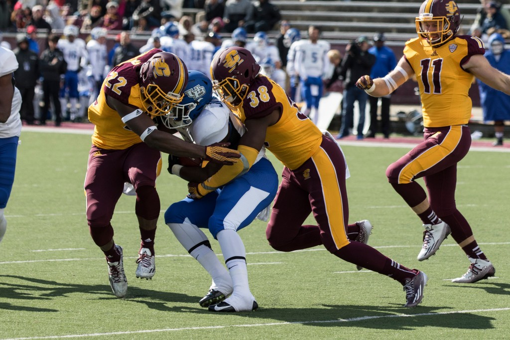 Gary Jones, 22, and Cameron Davis, 38 tackle the ball carrier during the football game against the University at Buffalo on the campus of Central Michigan University, Mt. Pleasant, MI, Saturday, October 17, 2015.