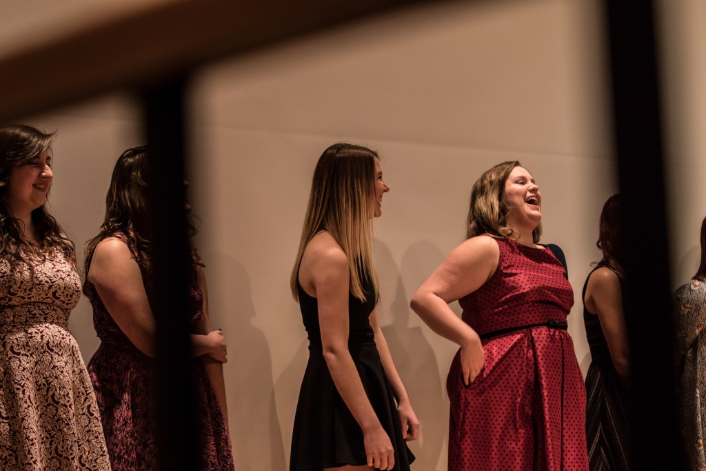Sara Muether, black dress, and Rachel Harrison, red dress, laugh together during the Fences presentation in the Park Library Auditorium on the campus of Central Michigan University, Mt. Pleasant, Michigan, Saturday, November 14, 2015.