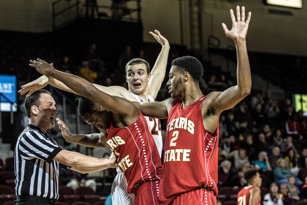Luke Meyer, 24, gets tangled up with two Ferris State players during the game against Ferris State University in McGuirk Arena on the campus of Central Michigan University, Mt. Pleasant, Michigan, Saturday, November 7, 2015.