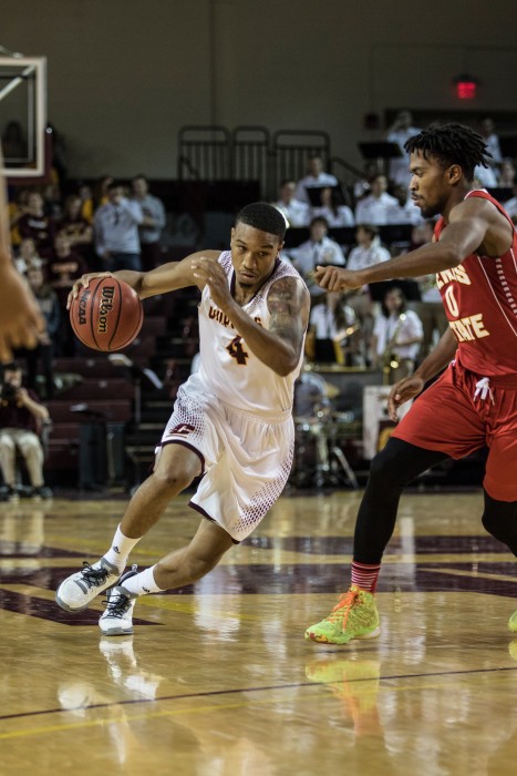 Rayshawn Simmons, 4, drives the lane against Noah King, 0, during the game against Ferris State University in McGuirk Arena on the campus of Central Michigan University, Mt. Pleasant, Michigan, Saturday, November 7, 2015.