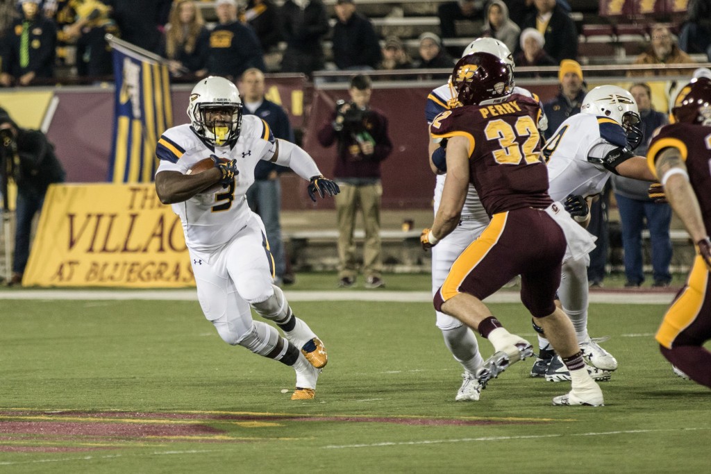 Kareem Hunt, 3, runs through the hole during the game against the University of Toledo at Kelly Shorts Stadium, on the campus of Central Michigan University, Mt. Pleasant, Michigan, Tuesday, November 10, 2015.