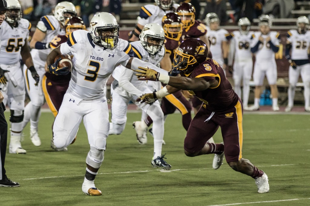 Kareem Hunt, 3, stiff arms Kavon Frazier, 5, during the game against the University of Toledo at Kelly Shorts Stadium, on the campus of Central Michigan University, Mt. Pleasant, Michigan, Tuesday, November 10, 2015.