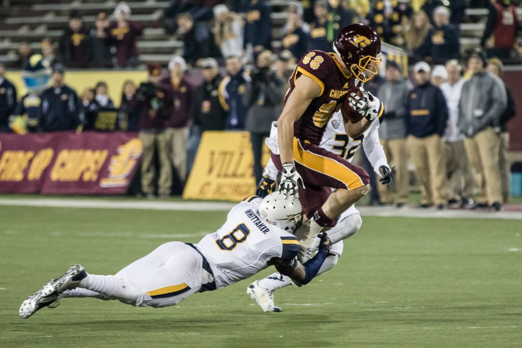 Jesse Kroll, 88, gets wrapped up by Chaz Whittaker, 8, during the game against the University of Toledo at Kelly Shorts Stadium, on the campus of Central Michigan University, Mt. Pleasant, Michigan, Tuesday, November 10, 2015.