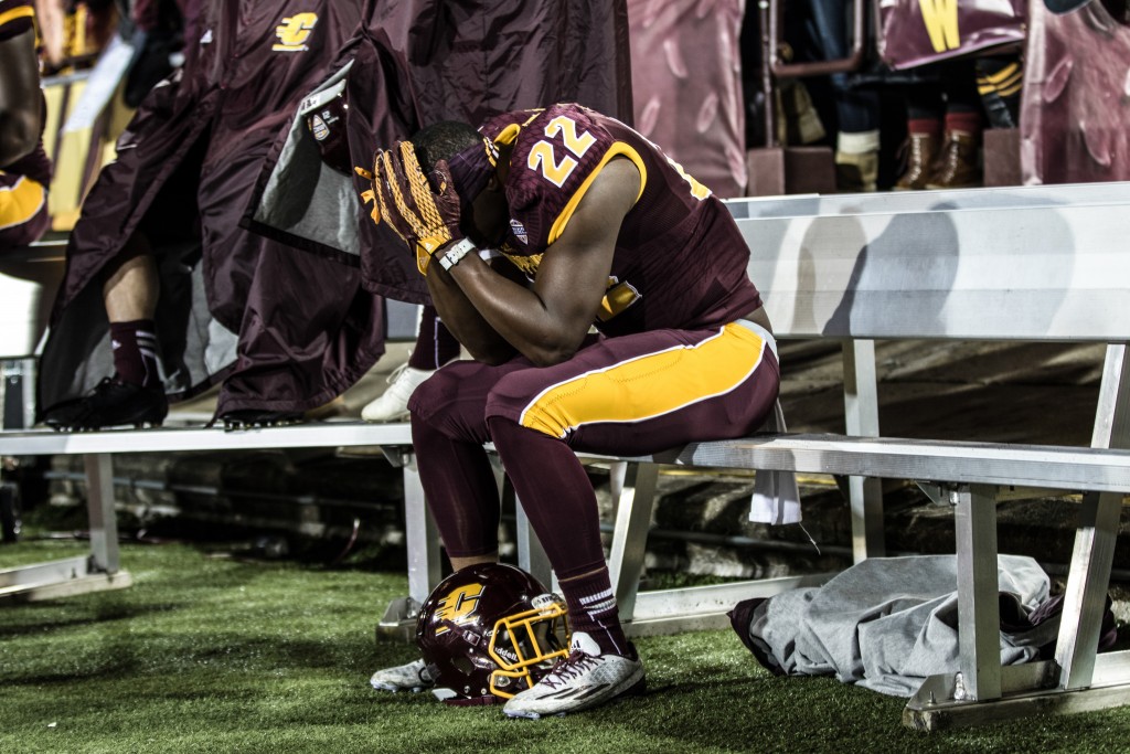 Gary Jones holds his head in his hands during the game against the University of Toledo at Kelly Shorts Stadium, on the campus of Central Michigan University, Mt. Pleasant, Michigan, Tuesday, November 10, 2015.